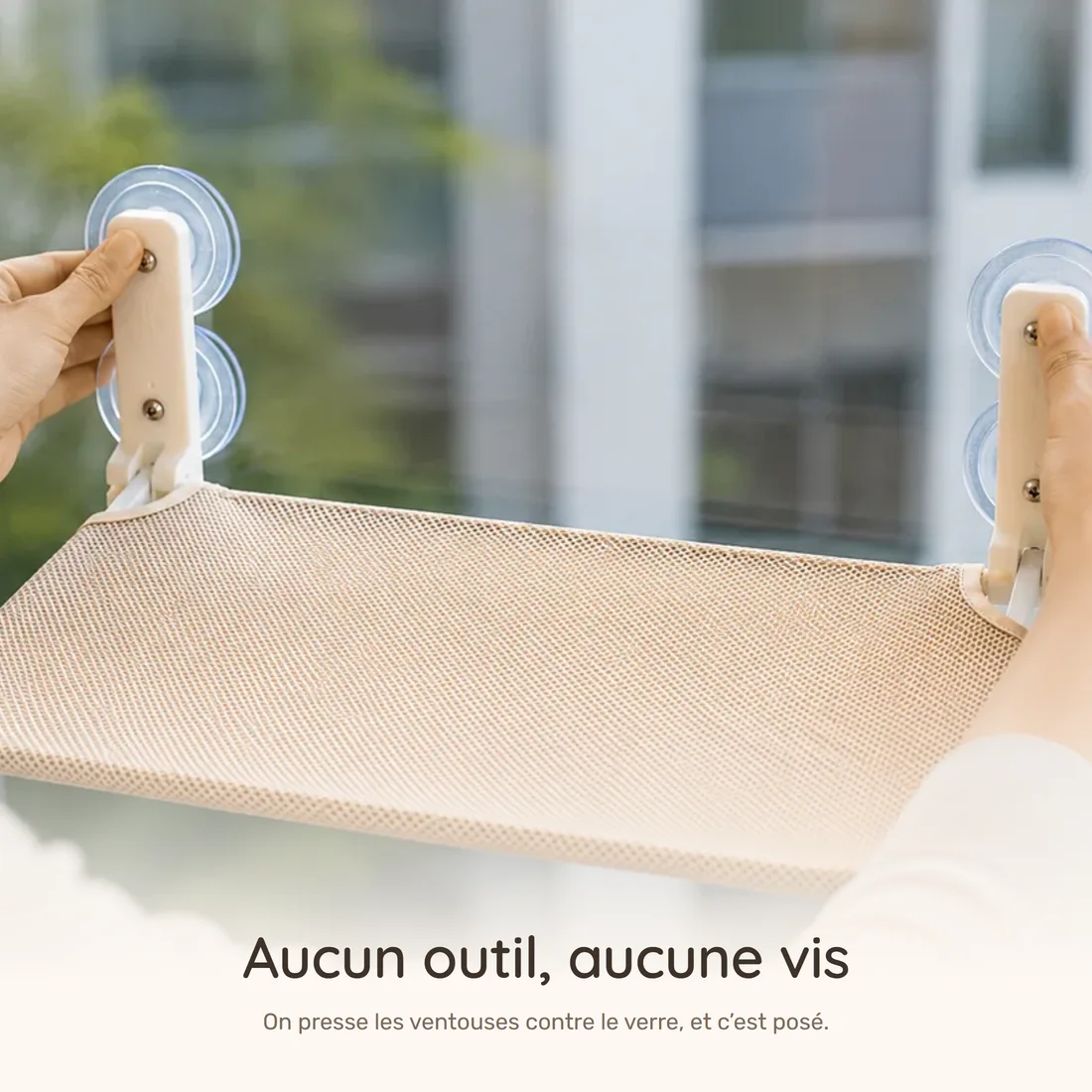 No tools, no screws — two hands pressing the platform's suction cups against the pane