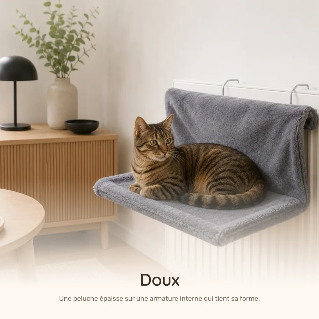 Soft — the plush radiator bed hooked onto a radiator, a tabby cat settled inside