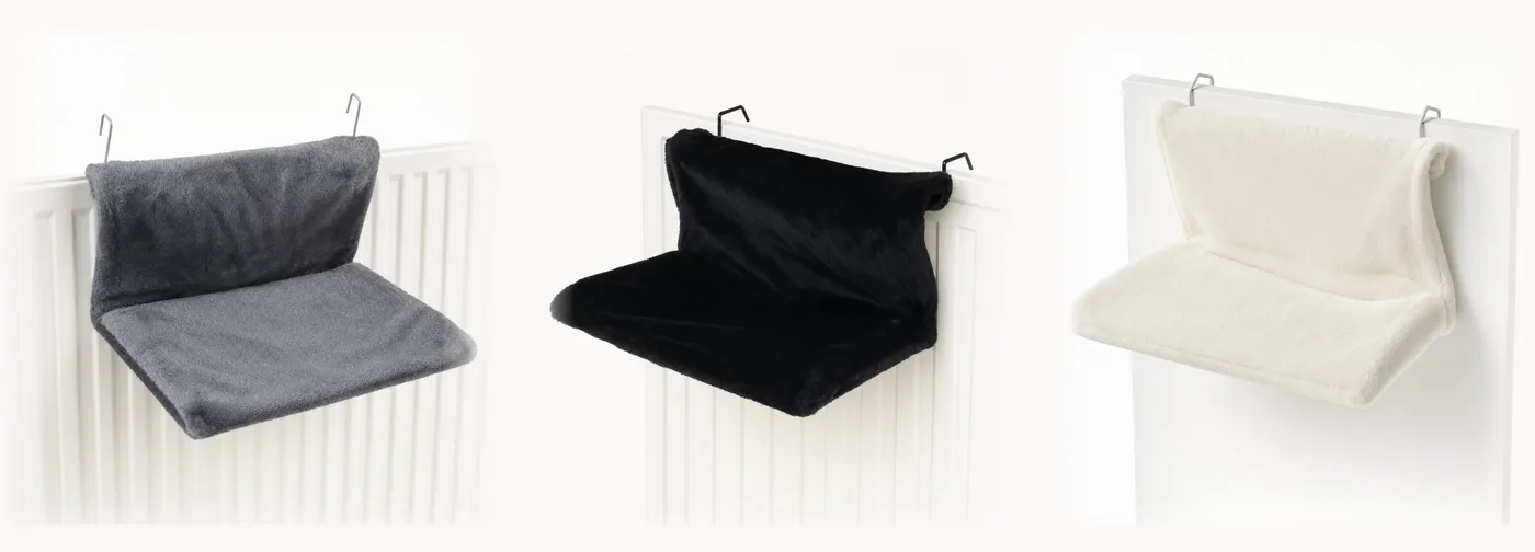 The three colors of the radiator bed side by side: gray, black and cream plush, metal hooks visible on all three